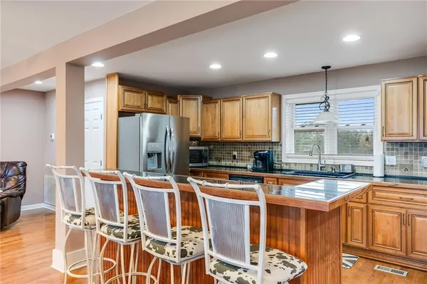 a kitchen with stainless steel appliances granite countertop a sink and cabinets