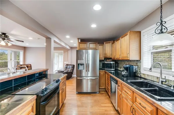 a kitchen with stainless steel appliances a sink stove and refrigerator