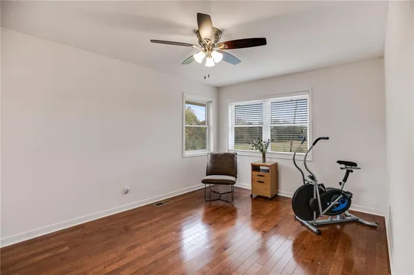 a view of a room with gym equipment and a window