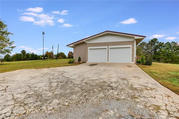 a view of a house with a yard and garage