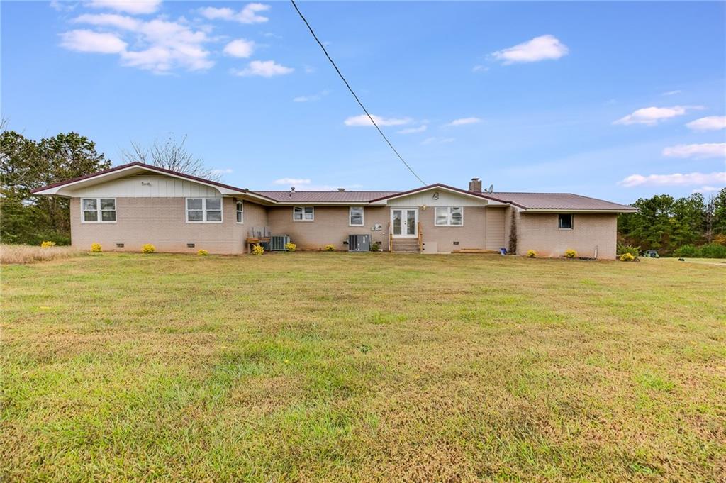 6792 Rockmart Road Southeast Silver Creek, GA 30173 - Photo 30 of 43 a big white house with a big yard and large trees