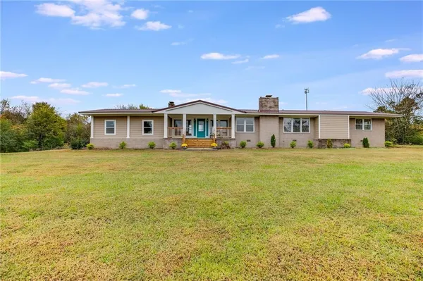 a front view of a house with a big yard