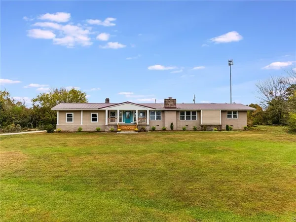 a front view of a house with a garden