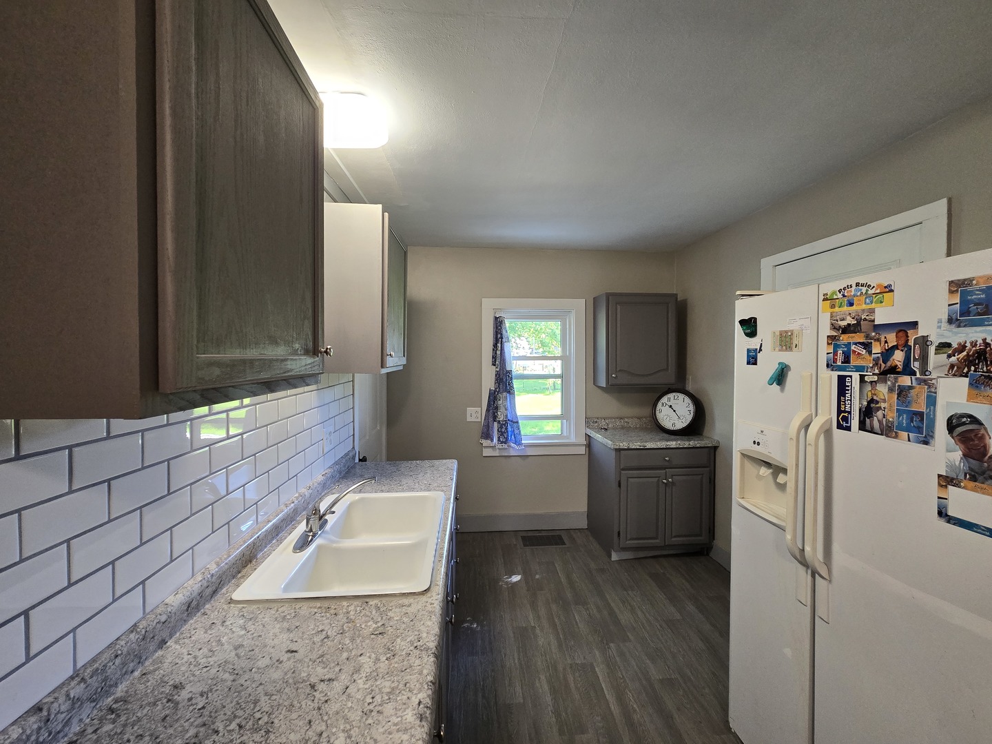 201 West Grove Road Sterling, IL 61081 - Photo 12 of 19 a room with a couch and a stove top oven