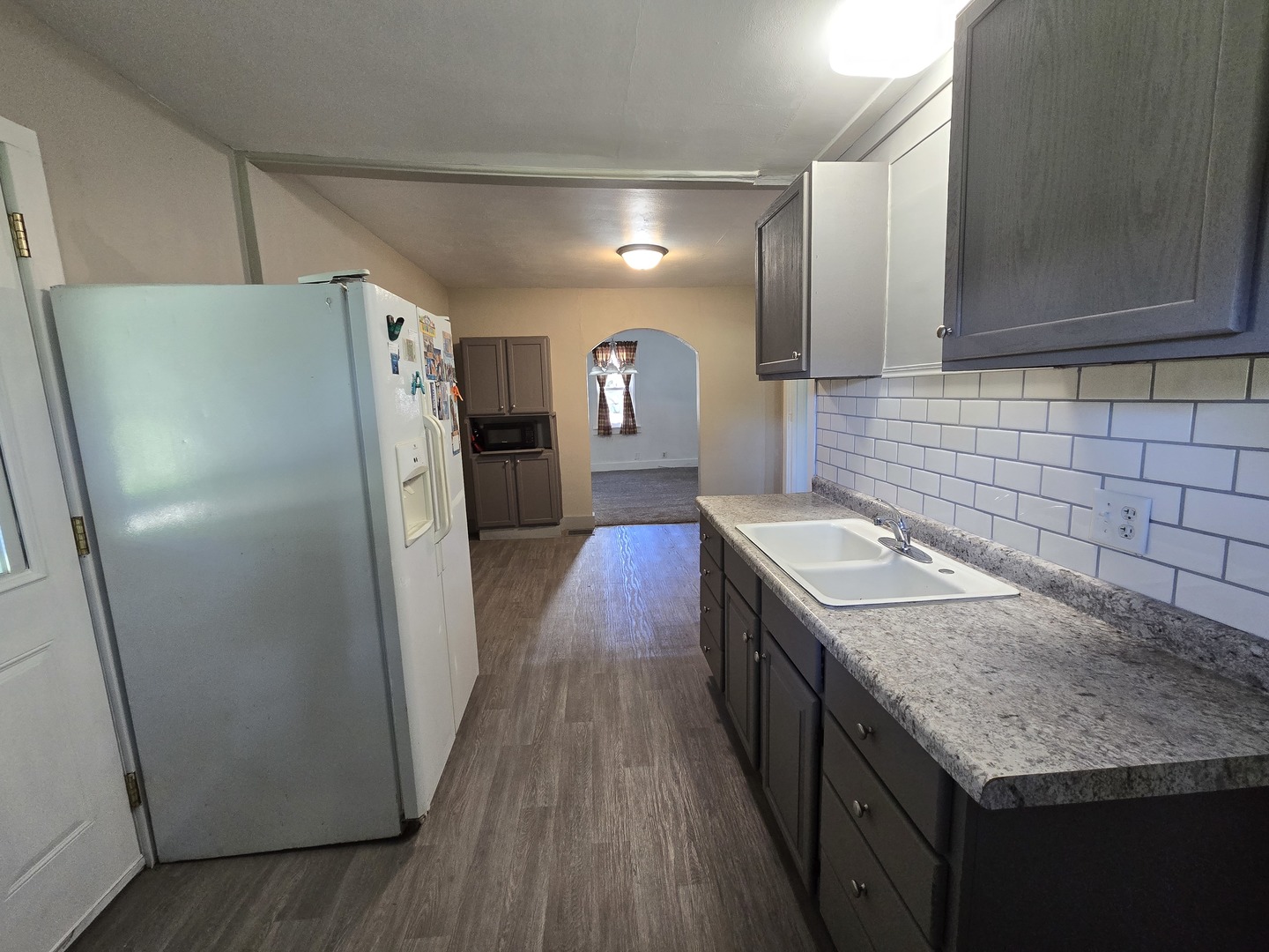 201 West Grove Road Sterling, IL 61081 - Photo 14 of 19 a kitchen with a sink a refrigerator and a stove top oven
