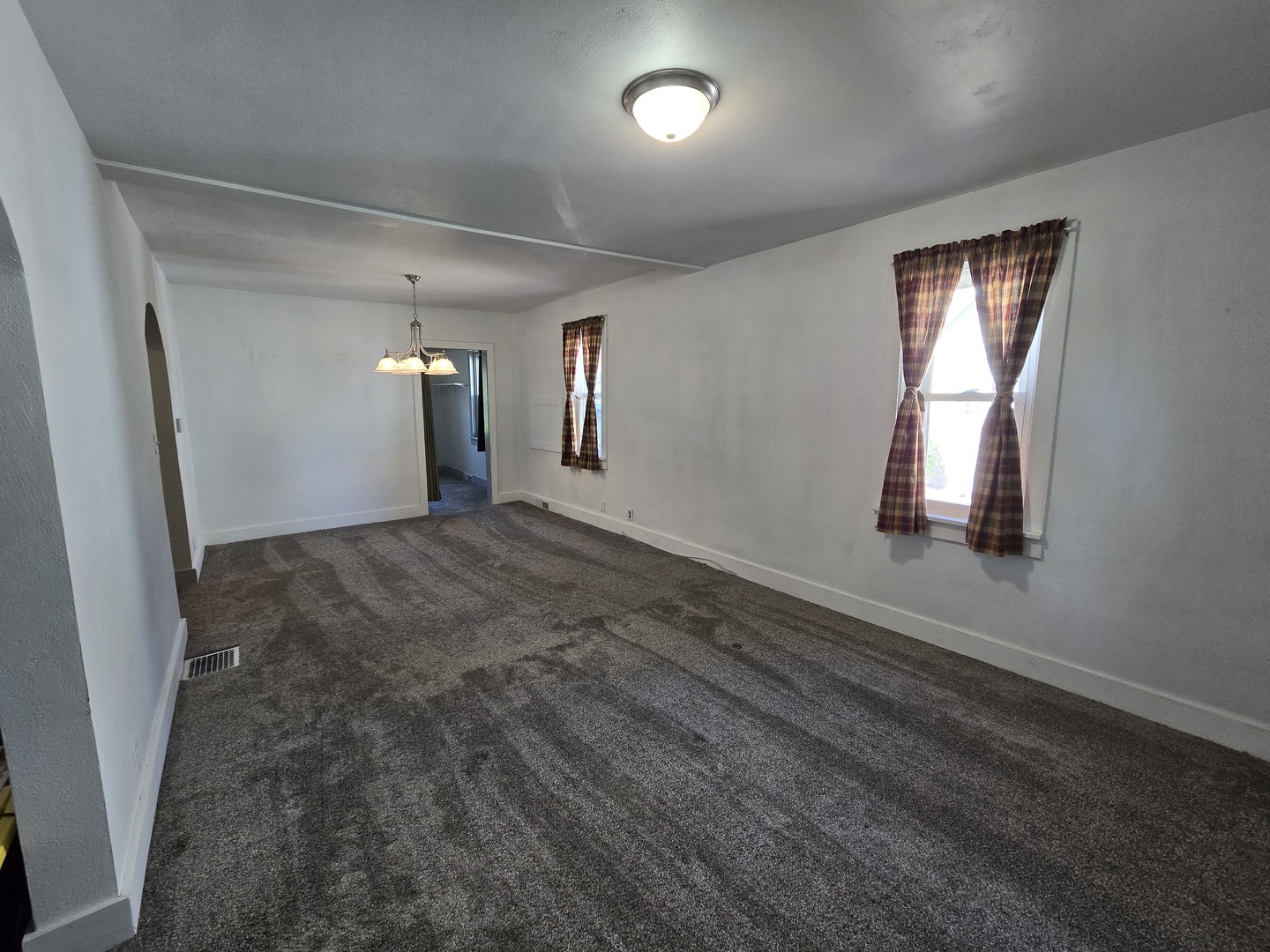 201 West Grove Road Sterling, IL 61081 - Photo 2 of 19 an empty room with wooden floor and windows