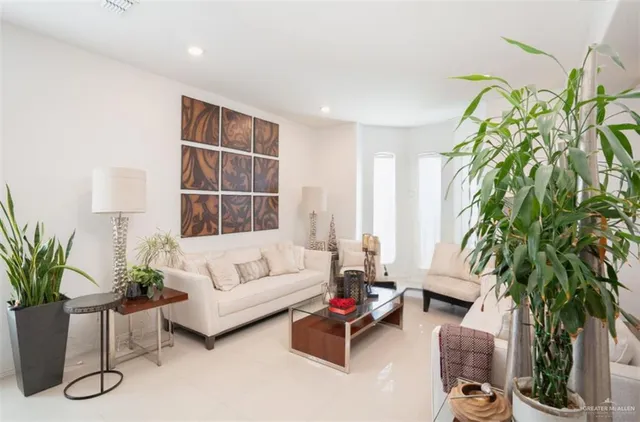 a living room with furniture and a floor to ceiling window