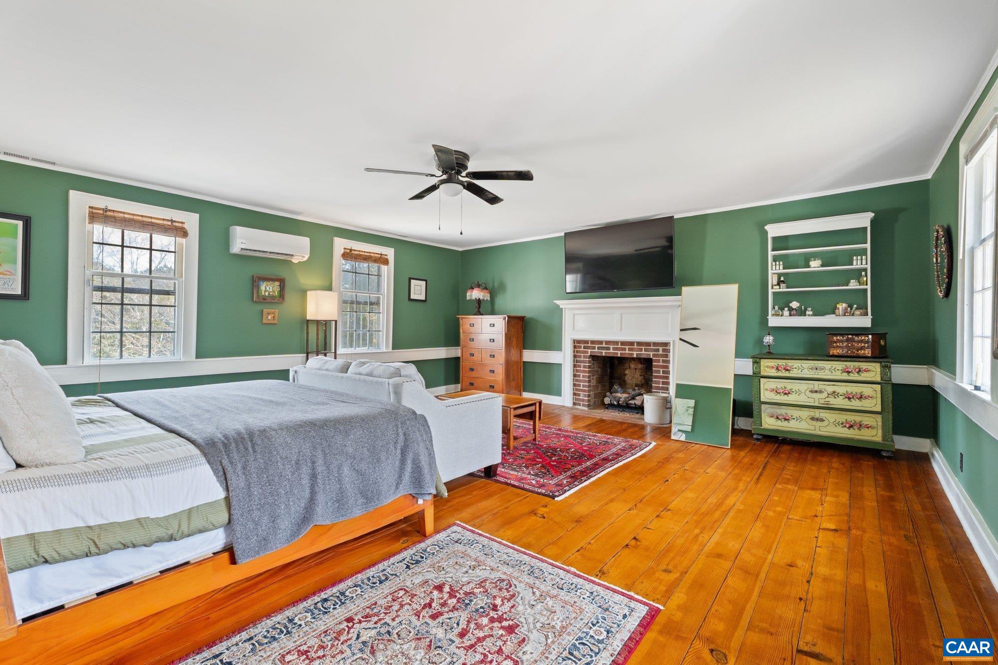14910 Western Mill Road Lawrenceville, VA 23868 - Photo 37 of 73 a spacious bedroom with a bed and a fireplace