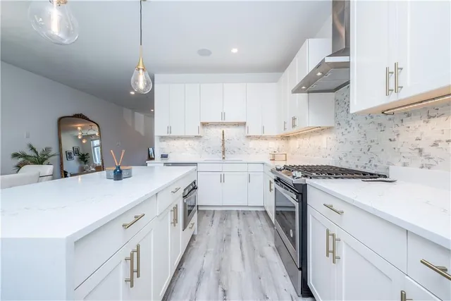 a kitchen with a sink stove and cabinets