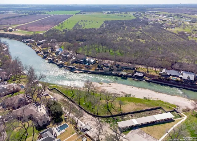 a view of a swimming pool with a yard