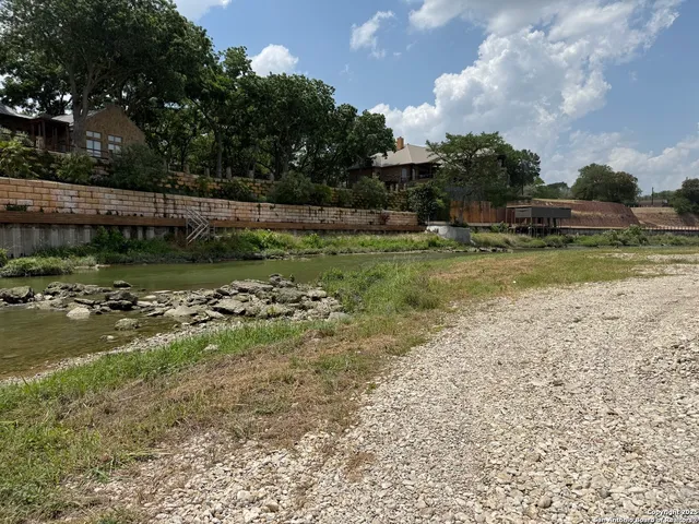 a view of a lake with houses in the background