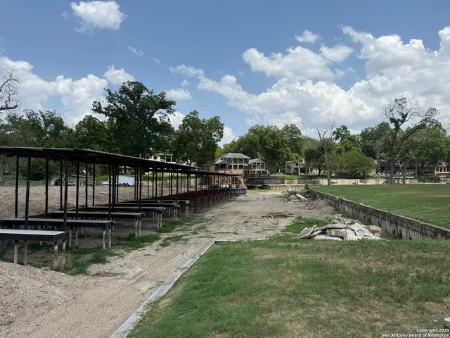 a view of a lake with a yard and a large window
