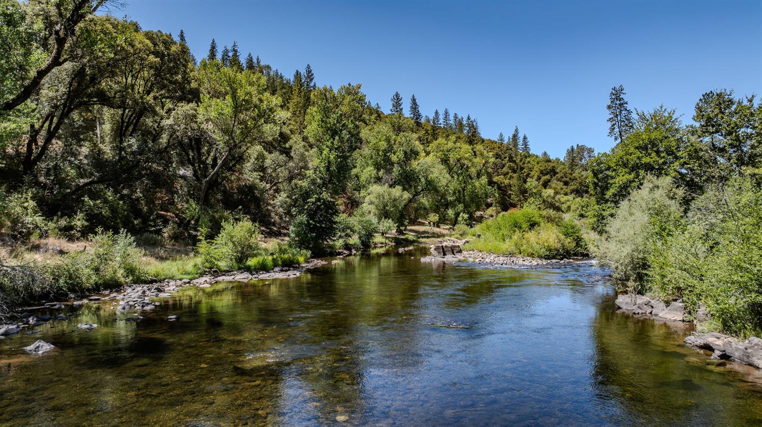0 Electra Road Jackson, CA 95642 - Photo 17 of 51 a view of a lake with houses in the background