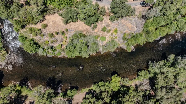 an aerial view of residential house with outdoor space and trees all around