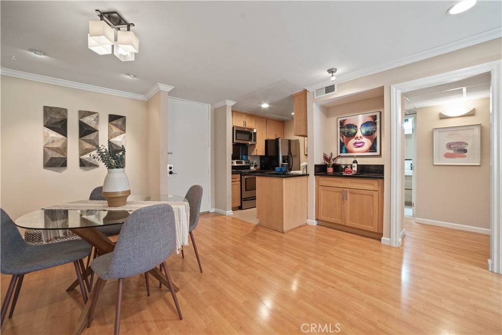 8108 Raintree Circle Culver City, CA 90230 - Photo 3 of 18 a view of a dining room with furniture and wooden floor