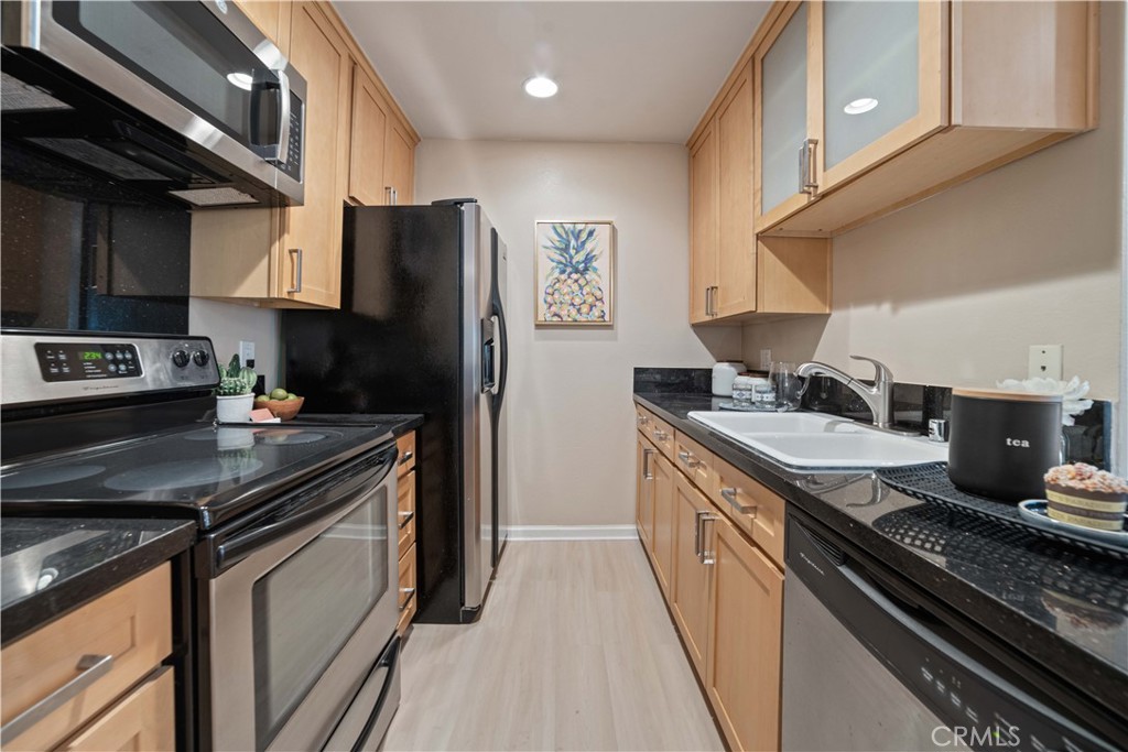 8108 Raintree Circle Culver City, CA 90230 - Photo 5 of 18 a kitchen with stainless steel appliances granite countertop a stove and a refrigerator