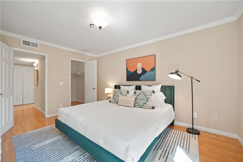 8108 Raintree Circle Culver City, CA 90230 - Photo 7 of 18 a bedroom with a large bed and a chandelier