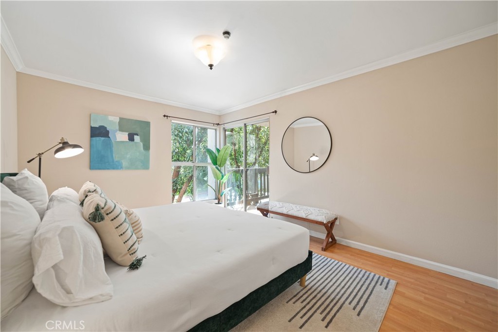 8108 Raintree Circle Culver City, CA 90230 - Photo 8 of 18 a bedroom with a bed mirror and window