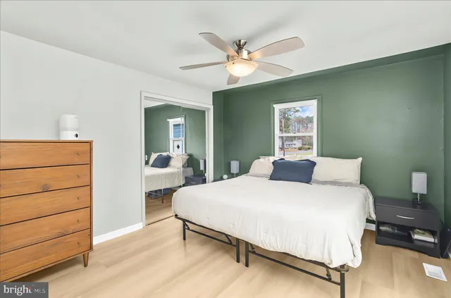 a bedroom with a large bed and a chandelier