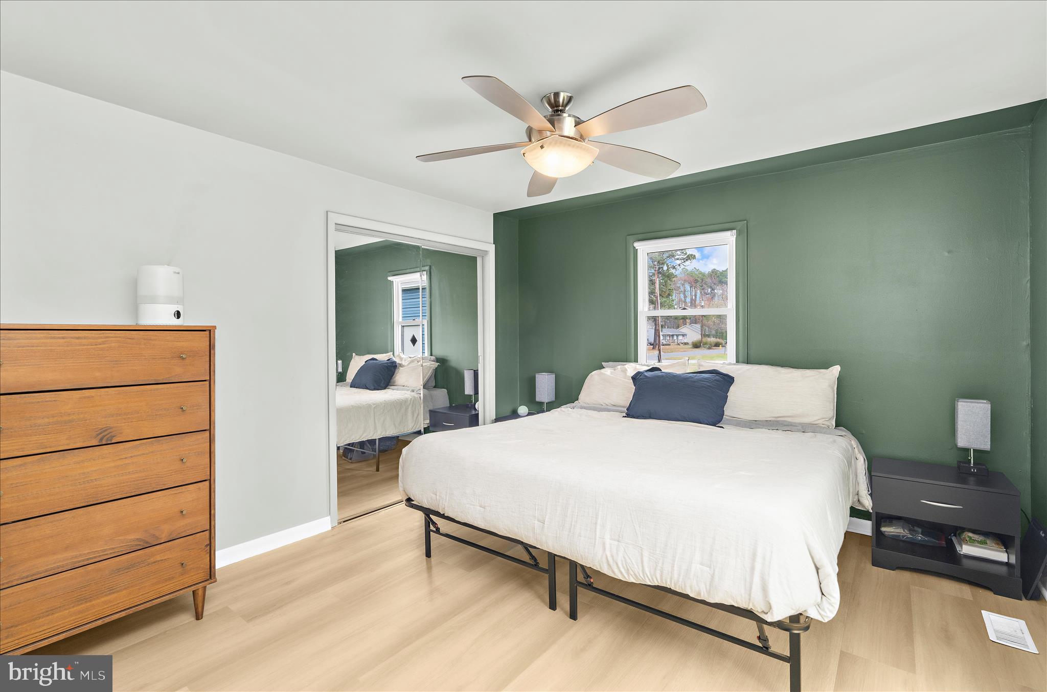 116 Talbot Road Stevensville, MD 21666 - Photo 12 of 33 a bedroom with a large bed and a chandelier