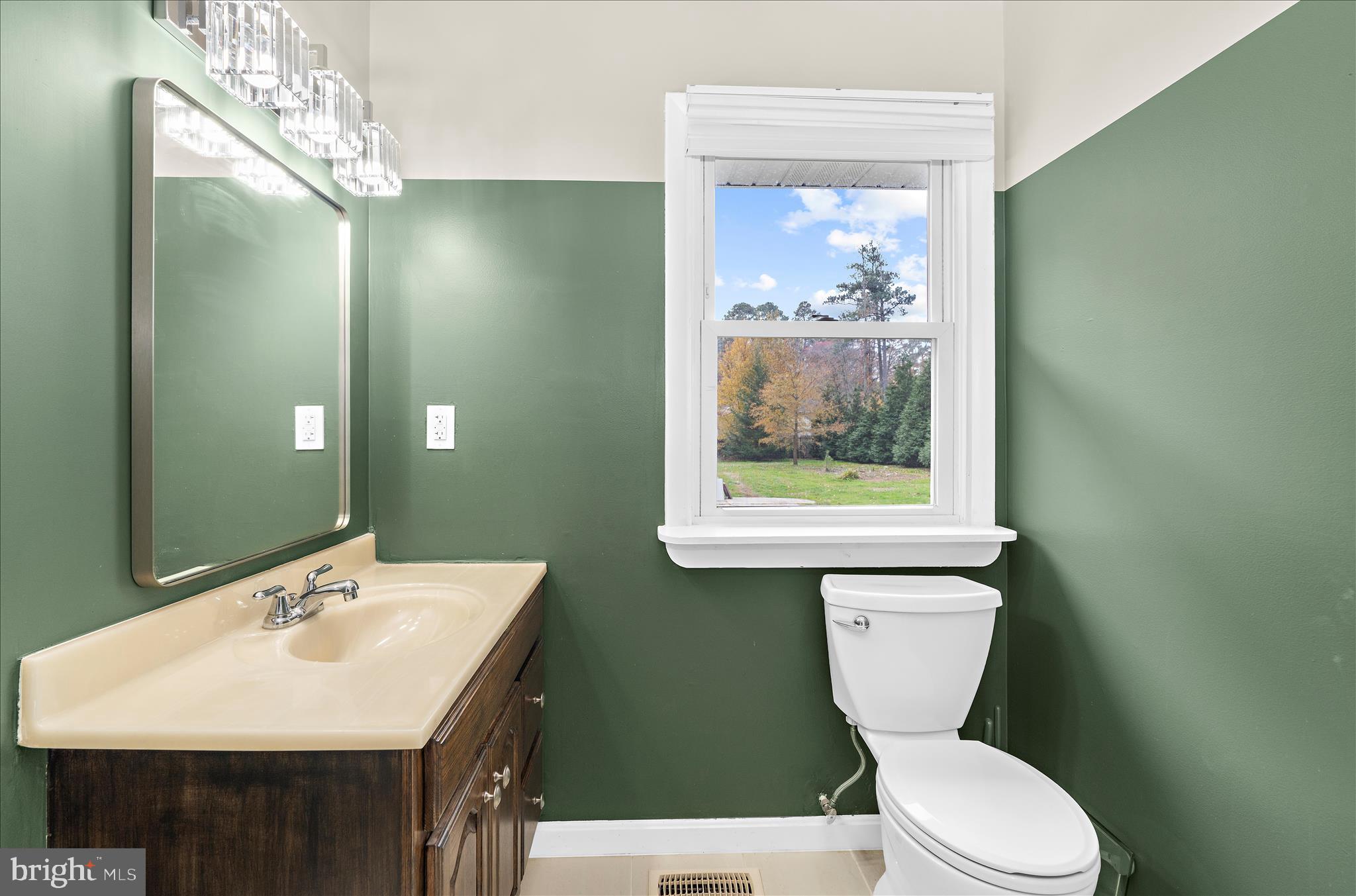 116 Talbot Road Stevensville, MD 21666 - Photo 15 of 33 a bathroom with a toilet a sink and a mirror