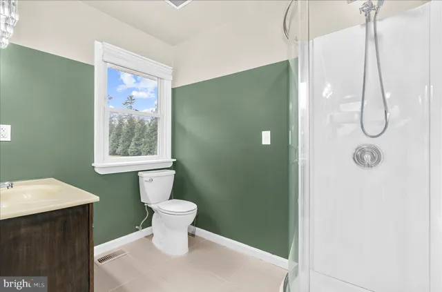 a bathroom with a toilet sink and shower