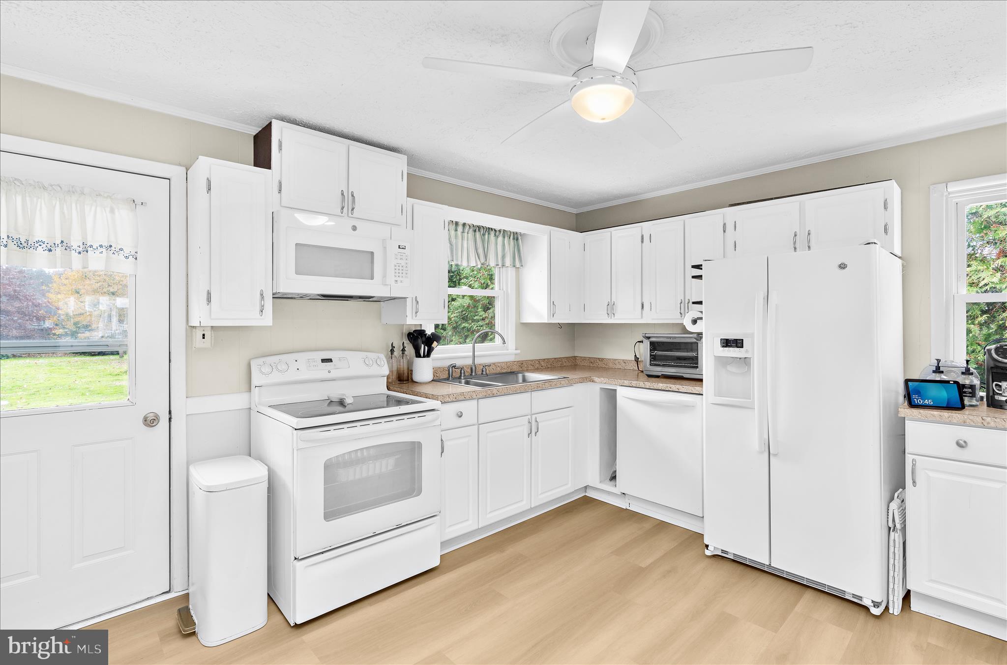 116 Talbot Road Stevensville, MD 21666 - Photo 8 of 33 a kitchen with white cabinets and white appliances