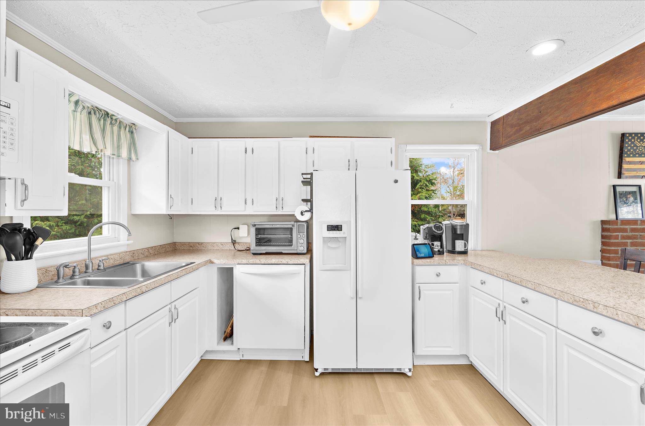 116 Talbot Road Stevensville, MD 21666 - Photo 10 of 33 a kitchen with white cabinets and white appliances
