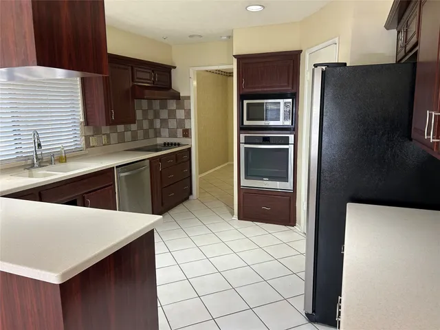 a kitchen with stainless steel appliances cabinets and a sink