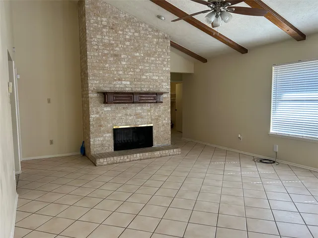 a view of an empty room with a fireplace
