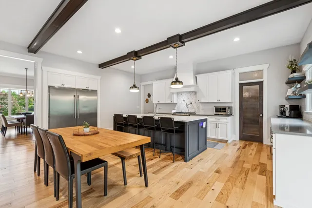 a kitchen with a table chairs stove and cabinets