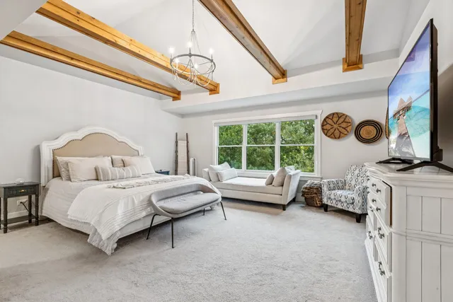 a bedroom with a bed a dresser and a closet