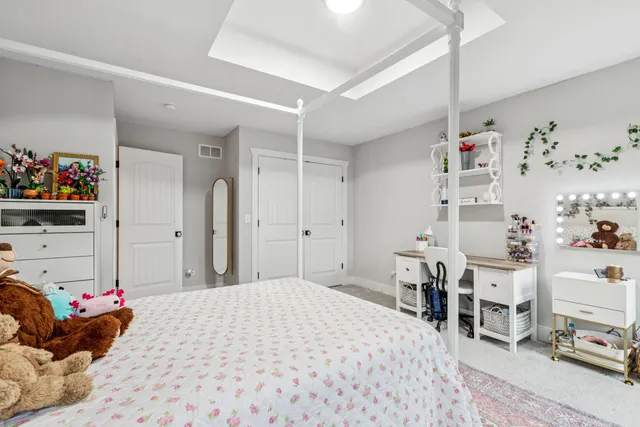 a bedroom with furniture and a window