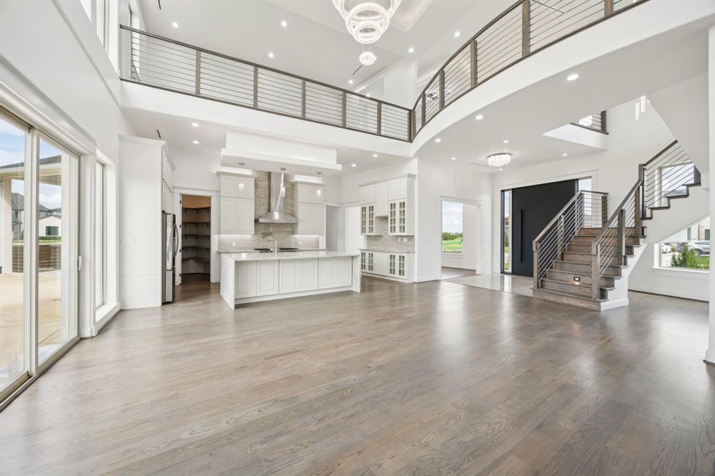 1933 Noe Boulevard Heath, TX 75126 - Photo 11 of 40 Stunning great room with over 20ft ceilings a stunning chandelier perfect for entertaining.