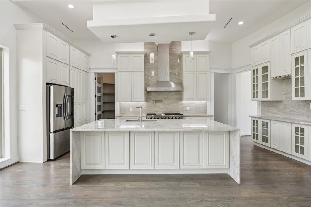 1933 Noe Boulevard Heath, TX 75126 - Photo 12 of 40 Chefs kitchen with generous island featuring cellphone charger and electrical outlet tower that can be hidden