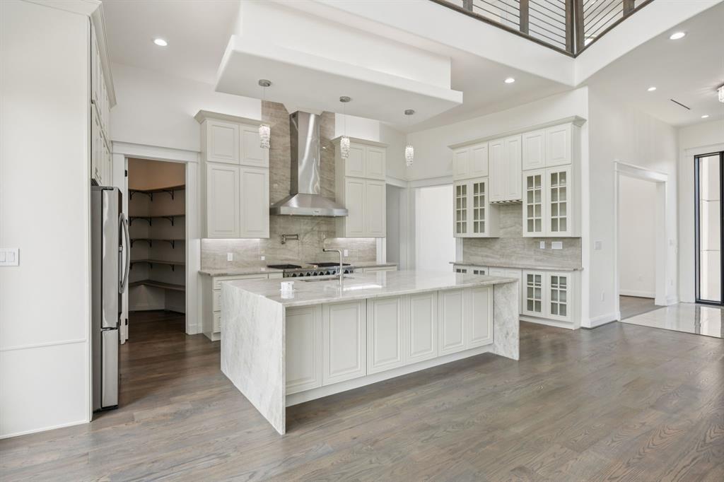 1933 Noe Boulevard Heath, TX 75126 - Photo 13 of 40 Chefs kitchen with generous island featuring cellphone charger and electrical outlet tower that can be hidden