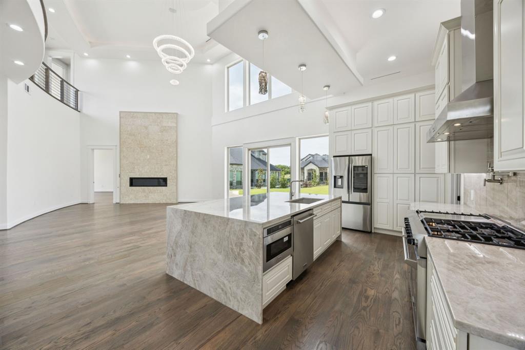 1933 Noe Boulevard Heath, TX 75126 - Photo 14 of 40 Chefs kitchen with generous island featuring cellphone charger and electrical outlet tower that can be hidden
