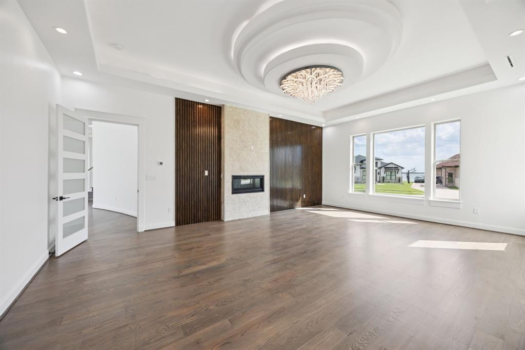 1933 Noe Boulevard Heath, TX 75126 - Photo 16 of 40 Spacious primary bedroom suite with ensuite bathroom,, fireplace and safe room