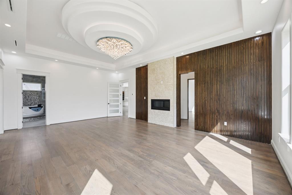 1933 Noe Boulevard Heath, TX 75126 - Photo 17 of 40 Spacious primary bedroom suite with ensuite bathroom,, fireplace and safe room