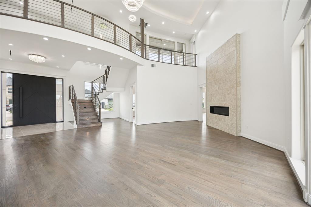 1933 Noe Boulevard Heath, TX 75126 - Photo 10 of 40 Spacious great room with a gas fireplace and chandelier