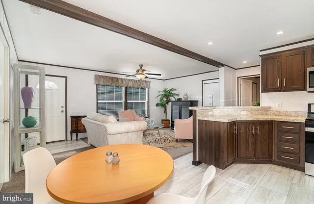 a living room with furniture a large window and a chandelier