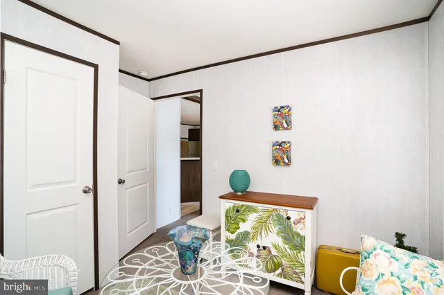 a view of a livingroom with furniture and bedroom view