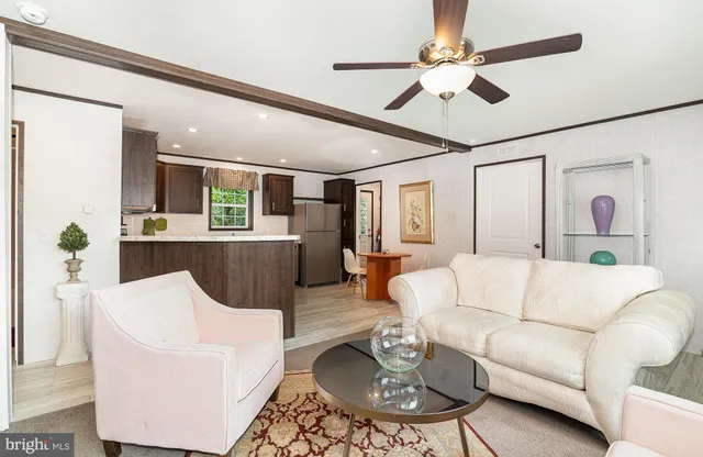 a living room with furniture a dining table and a chandelier
