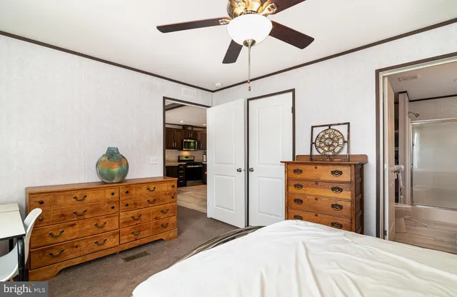 a bedroom with a bed and a dresser