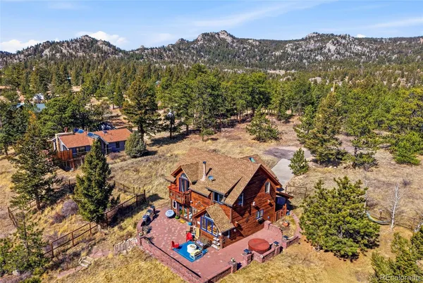 an aerial view of a house with a yard