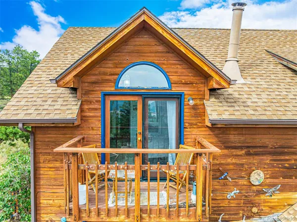 a view of a blue house next to a yard