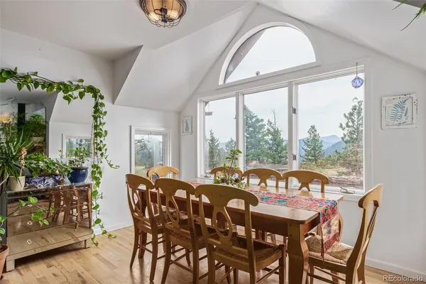 a view of a dining room with furniture window and wooden floor