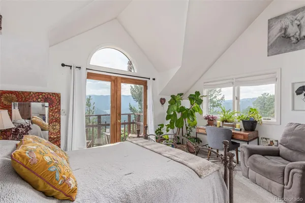 a bedroom with furniture and a large window