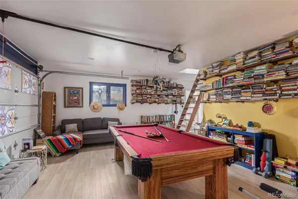 a room with furniture and view of kitchen