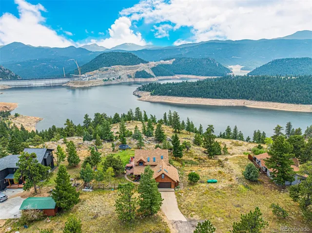 an aerial view of a house with a lake view